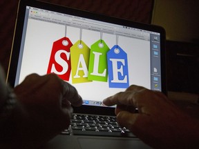 FILE - In this Dec. 12, 2016, photo, a person searches the internet for sales, in Miami. Retailers are scoring one win in the government-wide spending bill. The $1.7 trillion funding package contains legislation that will force online marketplaces like Amazon and Facebook to verify high-volume sellers amid heightened concerns about retail theft. Brick-and-mortar retailers have been voicing concerns about the amount of goods being stolen from their stores and subsequently sold online.