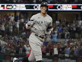 FILE - New York Yankees' Aaron Judge gestures as he runs the bases after hitting a solo home run, his 62nd of the season, during the first inning in the second baseball game of a doubleheader against the Texas Rangers in Arlington, Texas, Tuesday, Oct. 4, 2022. With the home run, Judge set the AL record for home runs in a season, passing Roger Maris. Judge won the American League MVP Award on Thursday, Nov. 17, 2022, in voting by a Baseball Writers' Association of America panel.