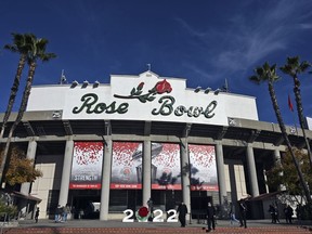 The exterior of the stadium is seen before the Rose Bowl NCAA college football game between Utah and Ohio State Saturday, Jan. 1, 2022, in Pasadena, Calif. Flipping the current college football playoff from four-teams to a 12-teams for the final two years of the current television contract will give those in charge of the postseason a look at how it works before committing to anything long term. But, The Granddaddy of Them All wants the CFP management committee to assure game organizers that their game will continue to be played annually on New Year's Day.
