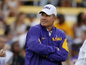 FILE - In this Oct. 17, 2015, file photo, LSU coach Les Miles watches his team warm up before an NCAA college football game against Florida in Baton Rouge, La. A former student who accused ex-LSU football coach Les Miles of sexual harassment in 2013 sought a $2.15 million settlement with LSU and Miles, according to documents filed in a former athletic department official's lawsuit.