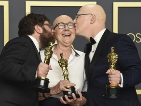 FILE - Jeff Reichert, from left, Julia Reichert, and Steven Bognar, winners of the award for best documentary feature for "American Factory", pose in the press room at the Oscars in Los Angeles on Feb. 9, 2020.