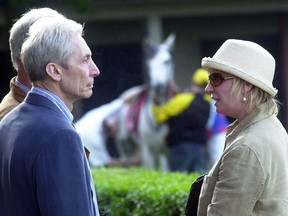 FILE - The Rolling Stones drummer Charlie Watts, second left, and wife Shirley, right, watch horses on the paddock at the Sluzewiec horse racing track in Warsaw, Poland, Saturday, May 25, 2002. Shirley Ann Watts, a former art student and prominent breeder of Arabian horses who met drummer Charlie Watts well before he joined the Rolling Stones and with him formed one of rock's most enduring marriages, has died at age 84. "Shirley died peacefully on Friday 16th December in Devon after a short illness surrounded by her family," her family announced Monday, Dec. 19, 2022.