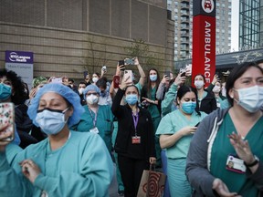 FILE - In this April 28, 2020, file photo Medical personnel attend a daily 7 p.m. applause in their honor outside NYU Langone Medical Center in New York. As more nurses leave their jobs in hospitals and health-care centers, foundations are pouring millions of dollars into efforts to ensure that more stay in the profession and get more out of the job than just the applause and pats on the back they got during the bleakest days of the pandemic.