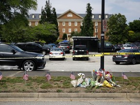 FILE - A makeshift memorial rests at the edge of a police cordon in front of a municipal building that was the scene of a shooting in Virginia Beach, Va., June 1, 2019. Several members of a state commission tasked with conducting an independent investigation of the 2019 mass shooting in Virginia Beach, have stepped down in recent months in the latter part of 2022, raising doubts among some whether the panel can perform its job.
