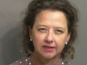 FILE - This booking photo provided by Glynn County, Ga., Sheriff's Office shows Jackie Johnson, the former district attorney for Georgia's Brunswick Judicial Circuit, after she turned herself in to the Glynn County jail in Brunswick, Ga, on Sept. 8, 2021. A judge has postponed a court hearing initially scheduled for Thursday, Dec. 29, 2022, for Johnson, a former Georgia prosecutor charged with meddling in the police investigation of the 2020 killing of Ahmaud Arbery. The judge has not set a new date. (Glynn County Sheriff's Office via AP, File)