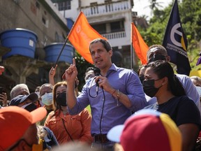 FILE - Venezuela opposition leader Juan Guaidó speaks to residents to present his unity plan to Venezuelans in Maiquetia, Venezuela, Feb. 19, 2022. A group of opponents of Venezuelan President Nicolas Maduro is looking to strip Guaidó of his authority as the internationally recognized head of the country's so-called interim government. Three of the four major opposition parties are expected to vote Thursday, Dec. 22, on the proposal to replace Guaidó with a horizontal style of leadership by committee.
