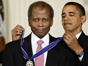 FILE - President Barack Obama, right, presents the 2009 Presidential Medal of Freedom to Sidney Poitier during ceremonies in the East Room at the White House in Washington on Aug. 12, 2009. Among the entertainers who died in 2022 was groundbreaking actor Poitier, who played roles with such dignity that it helped change the way Black people were portrayed on screen. Poitier, who died in January, became the first Black actor to win the Academy Award for Best Actor for his role in the 1963 film "Lilies of the Field."