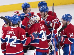 Montreal Canadiens goaltender Jake Allen is congratulated by teammates after stopping the Calgary Flames in the shootout to win 2-1 in NHL hockey action in Montreal, Monday, Dec. 12, 2022.