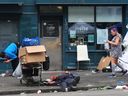 People loiter in front of the Insite clinic in Vancouver's Downtown Eastside on Aug. 3.