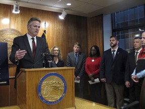 Alaska Gov. Mike Dunleavy, left, speaks to reporters during a news conference on his proposed budget, Thursday, Dec. 15, 2022, in Juneau, Alaska, with members of his Cabinet also pictured. Dunleavy called the budget a starting point for discussions with lawmakers, who convene for a new legislative session in January.