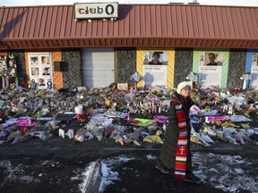 Rev. Paula Stecker of the Christ the King Lutheran Church stands in front of a memorial set up outside Club Q following last week's mass shooting at the gay nightclub in Colorado Springs, Colo., Tuesday, Nov. 29, 2022.