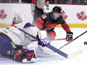 Canada's Connor Bedard drives to the net as Slovakia goaltender Patrik Andrisik makes a save during second period IIHF World Junior Hockey Championship pre-tournament hockey action in Moncton, N.B., on Wednesday, Dec. 21, 2022.