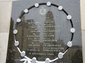The tower of the University de Montreal is reflected in the school's memorial plaque that names the 14 victims on the 30th anniversary of the 1989 Ecole Polytechnique attack on Friday, December 6, 2019 in Montreal.THE CANADIAN PRESS/Ryan Remiorz