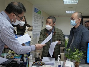 Peter Møller, center, attorney and co-founder of the Danish Korean Rights Group, submits the documents at the Truth and Reconciliation Commission in Seoul, South Korea on Nov. 15, 2022. South Korea's Truth and Reconciliation Commission will investigate the cases of dozens of South Korean adoptees in Europe and the United States suspected to have falsified or obscured children's origins during a child export frenzy in the mid- to late-1900s.