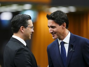 Prime Minister Justin Trudeau and Conservative leader Pierre Poilievre greet each other as they gather in the House of Commons on Parliament Hill, in Ottawa on Thursday, Sept. 15, 2022. A new poll says the Tories are retaining a small lead over the governing Liberals and have slightly widened the gap.