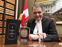 Anthony Rota, Speaker of the House of Commons, with a bottle of the new speaker's Canadian whiskey, a first in the history of the culture, December 15, 2022.