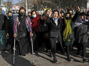 FILE - Afghan women chant slogans during a protest against the ban on university education for women, in Kabul, Afghanistan, Thursday, Dec. 22, 2022. The U.S. has condemned the Taliban for ordering non-governmental groups in Afghanistan to stop employing women, saying the ban will disrupt vital and life-saving assistance to millions. It is the latest blow to female rights and freedoms since the Taliban seized power last year and follows sweeping restrictions on education, employment, clothing and travel.(AP Photo, File)