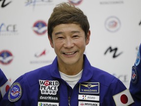 FILE - Space flight participant Yusaku Maezawa attends a news conference ahead of the expedition to the International Space Station at the Gagarin Cosmonauts' Training Center in Star City outside Moscow, Russia, on Oct. 14, 2021. Maezawa said Friday, Dec. 9, 2022 that K-pop star TOP will be among the eight crew members who will join him on a flyby around the moon on a SpaceX spaceship next year.