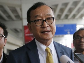 FILE - Cambodia's exiled opposition leader Sam Rainsy talks to the media upon arrival at Soekarno-Hatta International Airport in Tangerang, Indonesia on Nov. 14, 2019. A court in Cambodia on Thursday, Dec. 22, 2022, convicted 36 activists and former opposition lawmakers of conspiracy to commit treason, a local human rights group said. The 36, including former opposition leader Sam Rainsy and several leaders of his disbanded Cambodia National Rescue Party, were accused of trying to help exiled former lawmakers, including deputy party leader Mu Sochua, return home in January 2021 in defiance of a government ban.