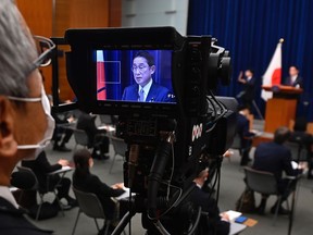 Japan's Prime Minister Fumio Kishida is seen on tv camera screen during his press conference at the prime minister's official residence in Tokyo, Friday, Dec. 16, 2022. In a major break from its strictly self-defense-only postwar principle, Japan adopted a national security strategy Friday declaring plans to possess preemptive strike capability and cruise missiles within years to give itself more offensive footing against threats from neighboring China and North Korea.