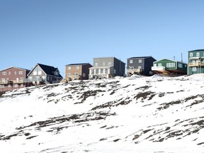 Houses are seen Saturday, April 25, 2015 in Iqaluit, Nunavut. Canada's housing advocate says investments in Inuit housing are "not adequate to remedy the human rights violations caused by the housing shortage."