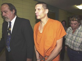 FILE - Scott Eizember, right, is escorted to Angelina County District Court with his lawyer, John Henry Tatum II, on Dec. 3, 2003, in Lufkin, Texas. The Texas Pardon and Parole Board decided Wednesday, Dec. 7, 2022, that Eizember, a man convicted in the shotgun slayings of an elderly couple in eastern Oklahoma in 2003 and sentenced to die, should not be spared from the death sentence.