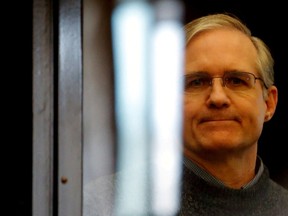 \Former U.S. Marine Paul Whelan stands inside a defendants' cage during his verdict hearing in Moscow, Russia June 15, 2020.