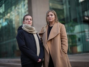 Jessica Payne, left, and her sister Calla Payne pose for a photograph outside B.C. Supreme Court, in Vancouver, B.C., Thursday, Dec. 15, 2022. Their father Martin Payne, 60, was killed in 2019 by two men who escaped from a Vancouver Island prison. Friends and relatives of murder victim Martin Payne say they are haunted by the actions of "two selfish, reckless" people who chose their victim because his home was near the prison where the men escaped.