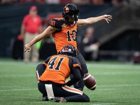 B.C. Lions' Sean Whyte (10) kicks a field goal as Stefan Flintoft holds during the first half of CFL football game against the Hamilton Tiger-Cats in Vancouver, on Thursday, July 21, 2022. The Lions have signed placekicker Whyte to a one-year extension.THE CANADIAN PRESS/Darryl Dyck