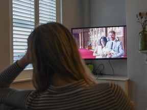 Georgia watches the Duke and Duchess of Sussex's controversial documentary being aired on Netflix at her home in Warwick, Britain, Thursday, Dec. 8, 2022. Britain's monarchy is bracing for more bombshells to be lobbed over the palace gates as Netflix releases the first three episodes of a new series. The show "Harry & Meghan" promises to tell the "full truth" about Prince Harry and his wife Meghan's estrangement from the royal family. The series debuted Thursday.