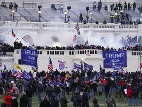 FILE - Violent insurrectionists, loyal to President Donald Trump, storm the Capitol in Washington on Jan. 6, 2021. Ronald Sandlin, a Tennessee man who authorities say came to Washington ahead of the Jan. 6, 2021, riot ready for violence in a car full of weapons and assaulted officers who were trying to defend the Capitol, has been sentenced to more than five years behind bars.