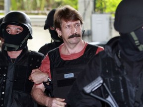 FILE - Suspected Russian arms smuggler Viktor Bout, center, is led by armed Thai police commandos as he arrives at the criminal court in Bangkok, Thailand in Oct. 5, 2010. Russia has freed WNBA star Brittney Griner on Thursday in a dramatic high-level prisoner exchange, with the U.S. releasing notorious Russian arms dealer Viktor Bout.