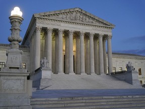 FILE - Light illuminates part of the Supreme Court building at dusk on Capitol Hill in Washington, Nov. 16, 2022. The court is set to hear arguments on Dec. 7 in a case from North Carolina, where Republican efforts to draw congressional districts heavily in their favor were blocked by a Democratic majority on the state Supreme Court because the GOP map violated the state constitution.