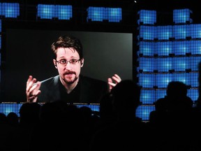 FILE - Former U.S. National Security Agency contractor Edward Snowden addresses attendees through video link at the Web Summit technology conference in Lisbon on Nov. 4, 2019. Snowden, who fled prosecution after he revealed highly classified U.S. surveillance programs, has received a Russian passport and taken the citizenship oath, his lawyer was quoted by Russian news agencies as saying Friday Dec. 2, 2022.
