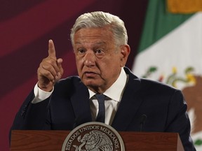 FILE - Mexico's President Andres Manuel Lopez Obrador speaks during his daily press conference at the National Palace, in Mexico City, Wednesday, June 22, 2022. Lopez Obrador appealed to the country's citizens Tuesday, Dec. 27, not to accept holiday handouts and gifts from drug gangs, after videos posted online showed garish pickup trucks handing out loads of gifts while bystanders described the drivers as members of the Jalisco drug cartel.