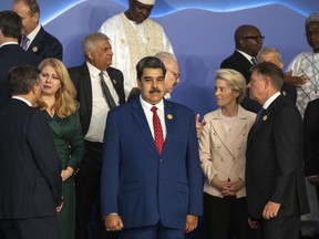 FILE - Venezuela's President Nicolas Maduro, center, stands next to the President of the European Commission Ursula von der Leyen, center right, as leaders prepare themselves for a group photo at the COP27 U.N. Climate Summit in Sharm el-Sheikh, Egypt, Nov. 7, 2022.