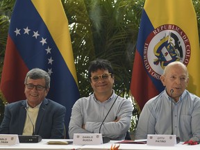 Pablo Beltran, left, representing the Colombian guerrilla National Liberation Army (ELN), Ivan Danilo Rueda, High Commissioner for Peace on behalf of the Colombian government, center, and Otty Pantino, of the Colombian government delegation, attend a press conference at the end the first part of peace talks at the Humboldt Hotel in Caracas, Venezuela, Monday, Dec. 12, 2022.