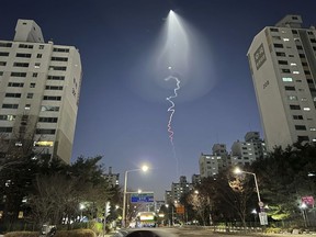 The light trail is seen in Goyang, South Korea, Friday, Dec. 30, 2022. South Korea's military confirmed it test-fired a solid-fueled rocket on Friday, after its unannounced launch triggered brief public scare of a suspected UFO appearance or a North Korean missile or drone flying.