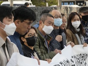 FILE - Peter Møller, fourth from left, attorney and co-founder of the Danish Korean Rights Group, attends a press conference with a group of South Korean adoptees in front of the Truth and Reconciliation Commission in Seoul, South Korea on Nov. 15, 2022. Nearly 400 South Koreans adopted as children by families in the West have requested South Korea's Truth and Reconciliation Commission investigate their adoptions through application deadline on Friday, Dec. 9, 2022, as Seoul faces growing pressure to reckon with a child export frenzy driven by dictatorships that ruled the country until the 1980s.