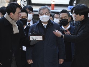 Former South Korean National Security Director Suh Hoon, center, arrives at the Seoul Central District Court in Seoul, South Korea, Friday, Dec. 2, 2022. South Korean prosecutors arrested the country's former national security director on Saturday over suspicions that he engaged in a cover-up to hide details and distort the circumstances surrounding North Korea's killing of a South Korean fisheries official near the rivals' sea boundary in 2020.