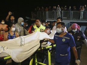 A rescued sailor from HTMS Sukhothai corvette is transferred on land at the Bangsaphan deep port in Prachuap Khiri Khan province, Thailand Monday, Dec. 19, 2022. The warship sank on Sunday in rough seas in the Gulf of Thailand.