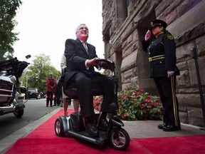 Former Ontario lieutenant-governor David Onley is saluted while arriving for his last full day in office at Queen's Park in Toronto on Monday, Sept. 22, 2014.