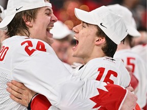 Ethan del Mastro, left, and MVP Connor Bedard celebrate Team Canada's gold-medal win Thursday at the 2023 IIHF World Junior Championship in Halifax.
