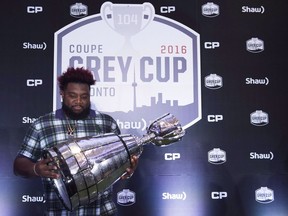 Calgary Stampeders offensive lineman Derek Dennis touches the Grey Cup ahead of the 104th CFL Grey Cup against the Ottawa Redblacks in Toronto on Thursday, November 24, 2016.&ampnbsp;For veteran CFL lineman Dennis, Damar Hamlin's horrific injury is another sober reminder of the potential perils of professional football. Hamlin, a defensive back with the Buffalo Bills, remains in critical condition in a Cincinnati hospital after suffering cardiac arrest on the field in the first quarter of Monday night's game versus the Bengals.