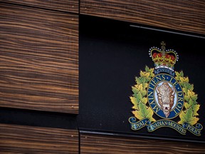 The RCMP logo is seen outside Royal Canadian Mounted Police "E" Division Headquarters, in Surrey, B.C., on Friday April 13, 2018. A judge has acquitted an RCMP officer who punched a man while leaving a bar in northern Manitoba.