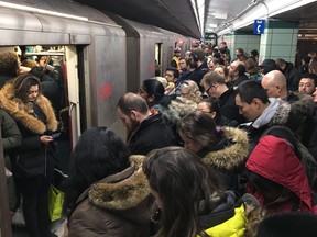 Commuters jam subway cars and the platform at Museum station on the TTC subway line in Toronto, Thursday, Jan.24, 2019.