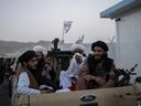 Taliban fighters sit in a pickup truck at the airport in Kabul, Afghanistan, Thursday, Sept. 9, 2021.