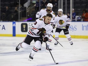 Chicago Blackhawks centre Max Domi (13) skates with the puck as left wing Jujhar Khaira (16) and center Colin Blackwell (43) follow during warmups before an NHL hockey game against the New York Rangers, Saturday, Dec. 3, 2022, in New York.