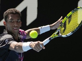 Felix Auger-Aliassime of Canada plays a backhand return to Francisco Cerundolo of Argentina during their third round match at the Australian Open tennis championship in Melbourne, Australia, Friday, Jan. 20, 2023.