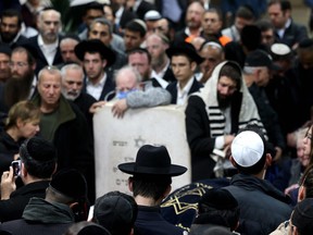 Mourners gather during the funeral of Eli Mizrahi and his wife, Natalie, who were victims of a shooting attack in east Jerusalem on January 27, 2023, in Bet Shemesh, Israel, on January 28, 2023. (Photo by MENAHEM KAHANA/AFP via Getty Images)